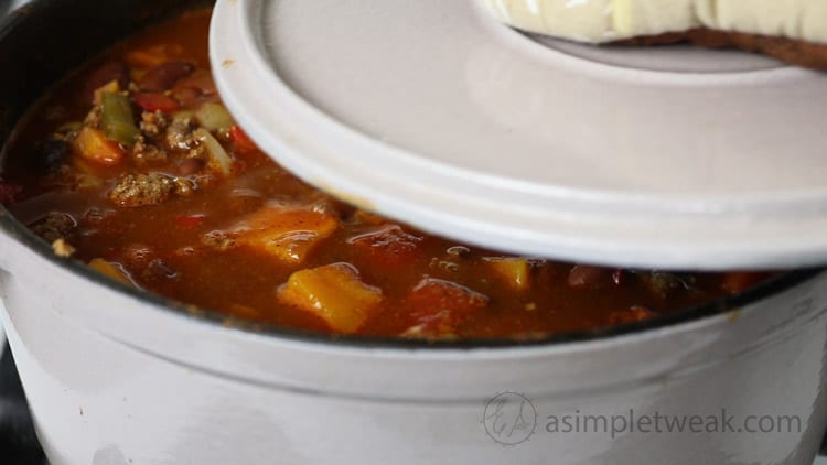 Cover the pot and let it cook for about 30 to 40ย minutes. Stir occasionally. if the mixture starts to dry off add water as needed. cover-the-pot-of-chili